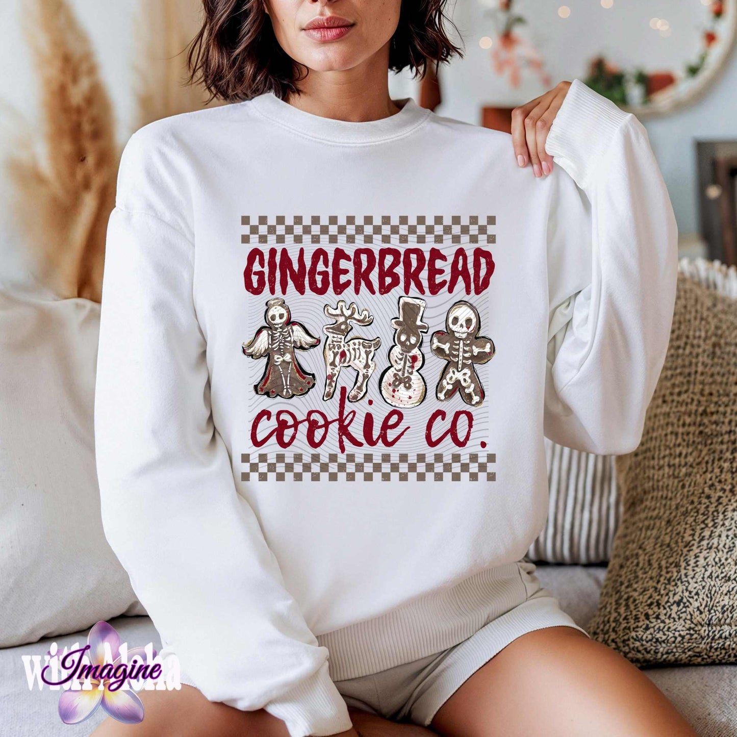 Woman wearing Halloween-themed sweatshirt with spooky skeleton gingerbread cookies from Gingerbread Cookie Co. for Christmas.