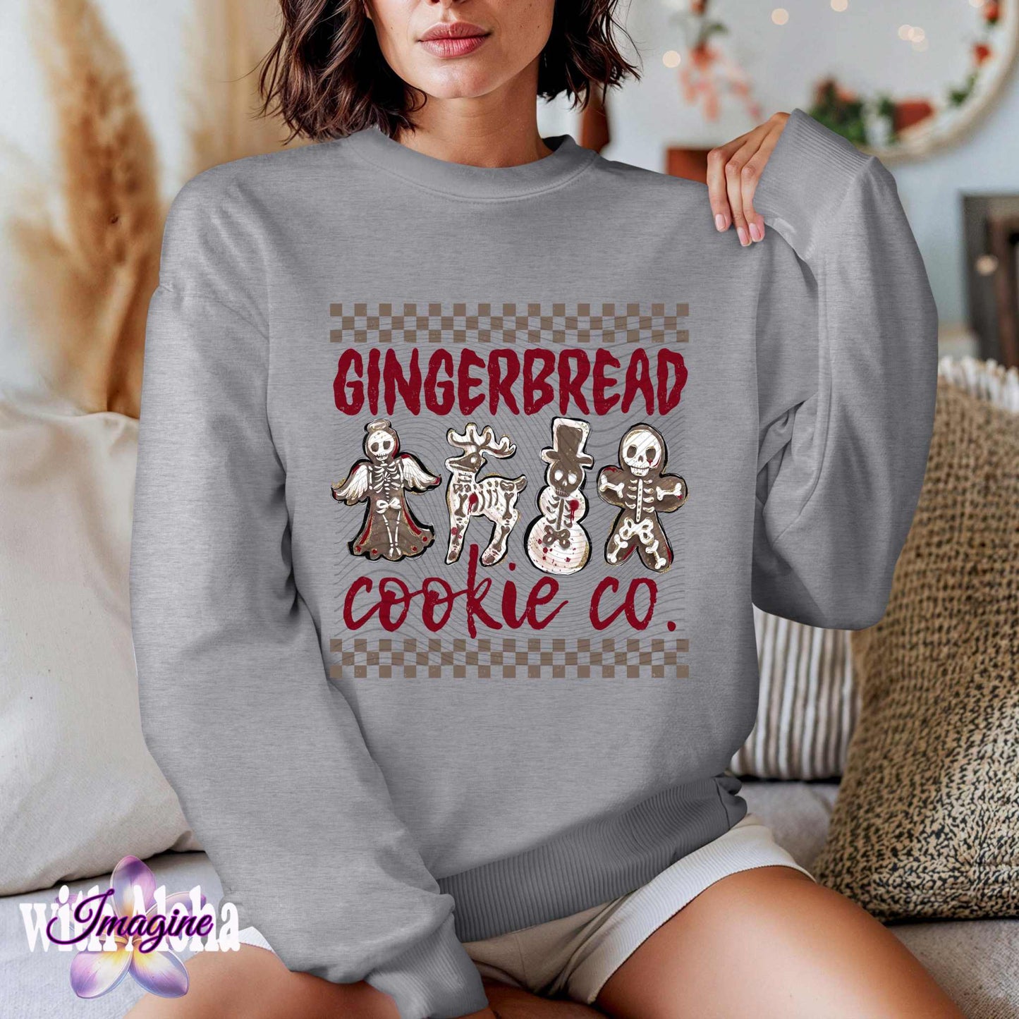 Woman wearing Spooky Gingerbread Cookie Co. Skeleton Christmas Cookie Art sweatshirt with Halloween-themed holiday design