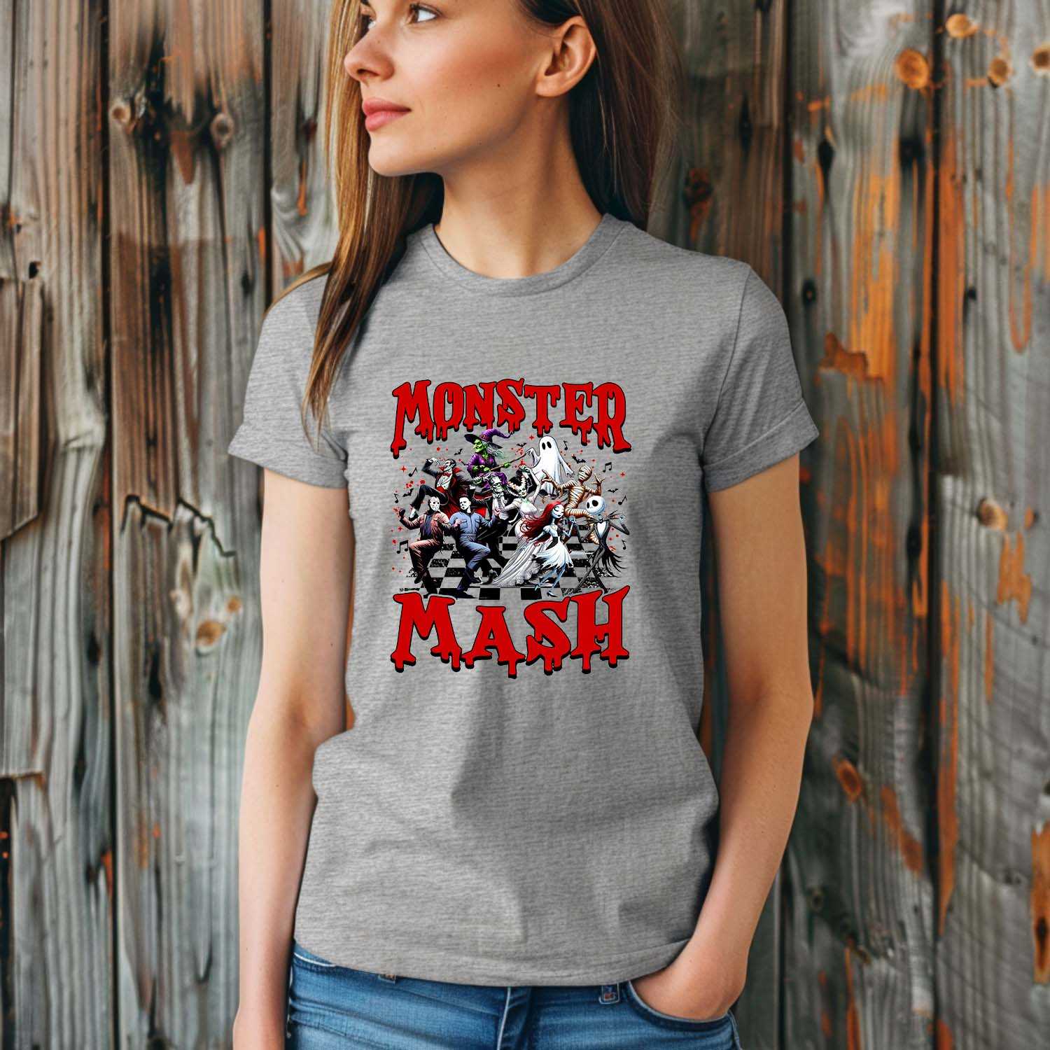 Woman wearing Monster Mash Halloween Graphic Tee with spooky characters, standing in front of wooden background.